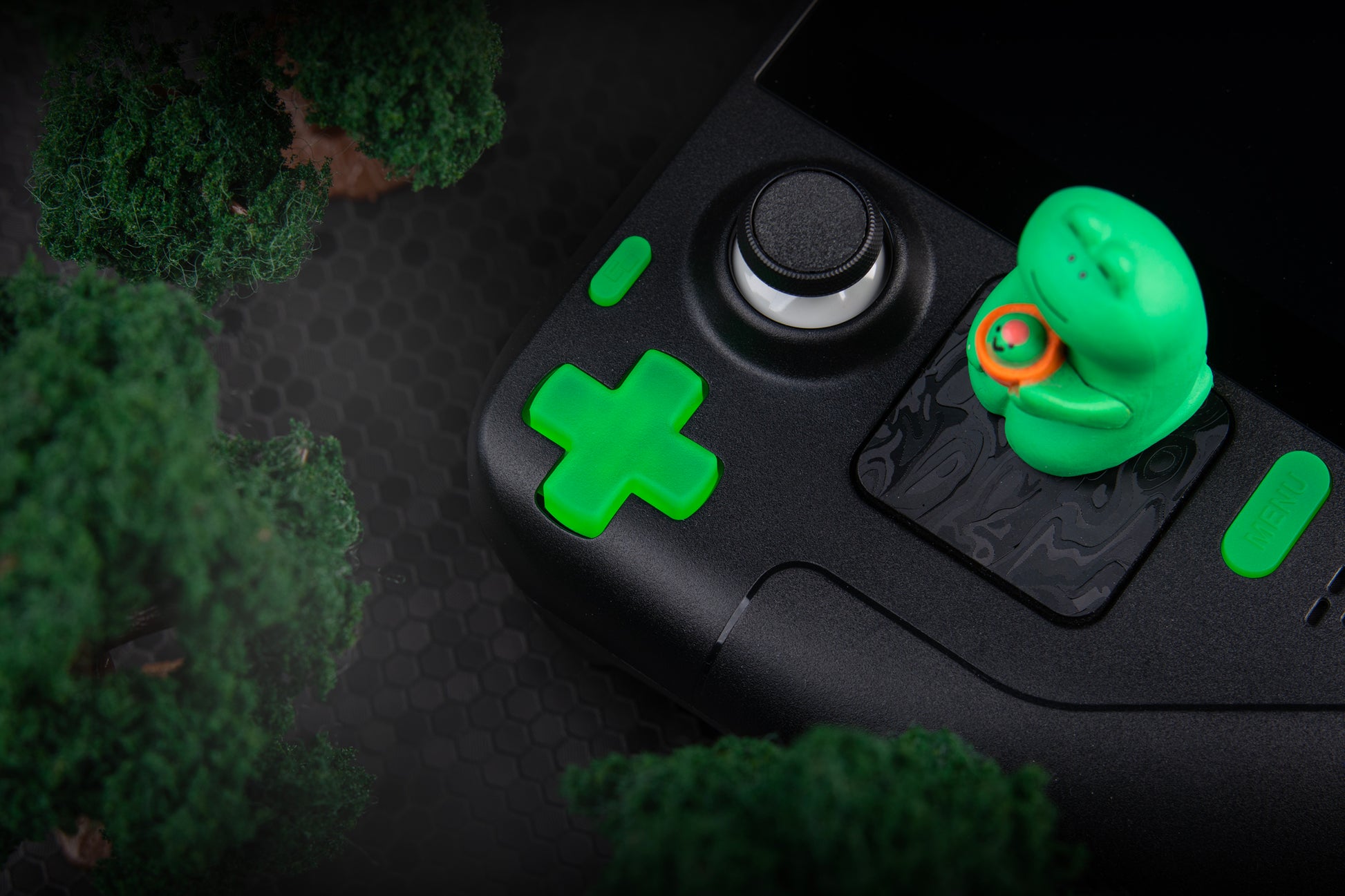 lime green dpad in steam deck with cute frog figure sitting next to it