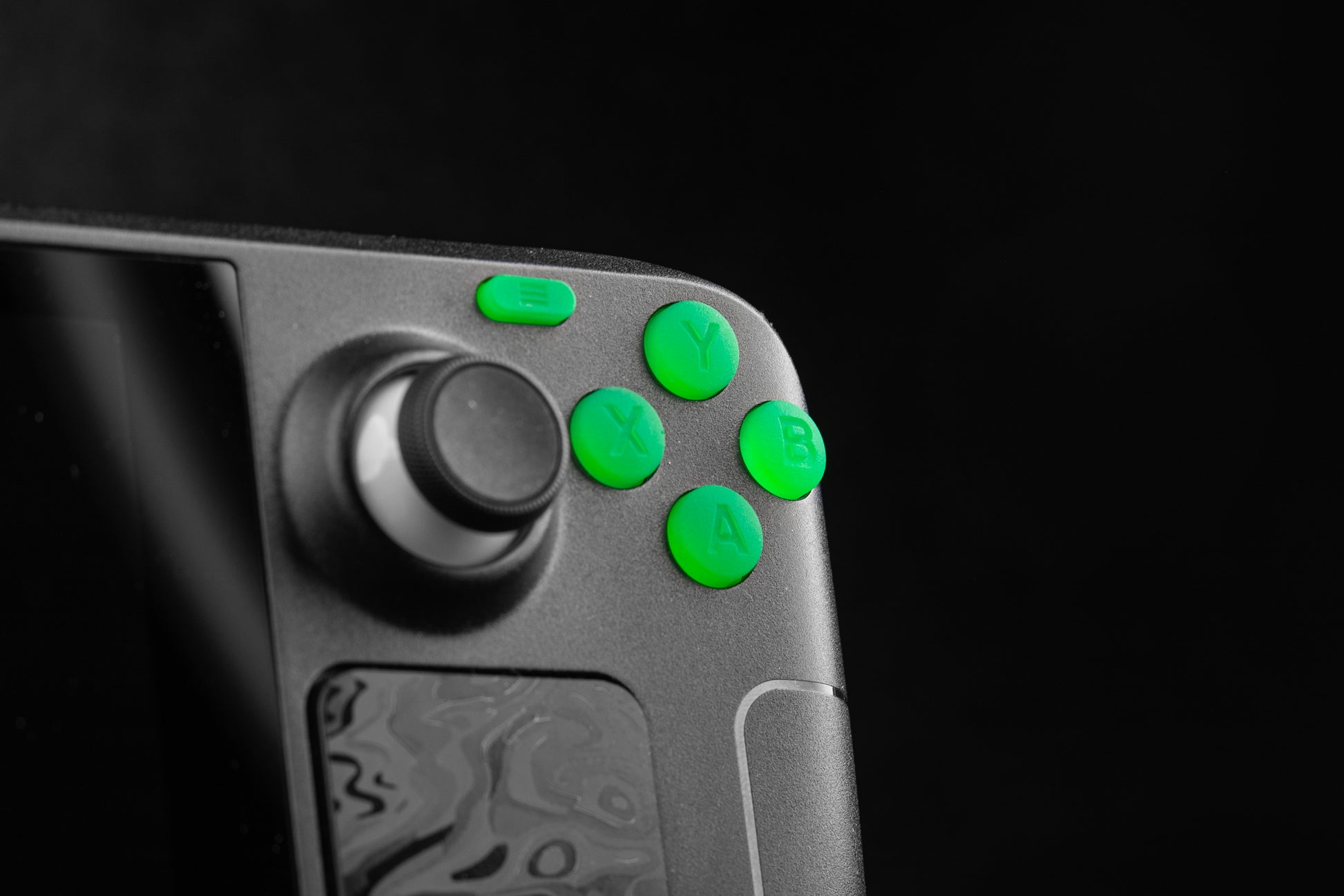 close up of steam deck with lime green abxy on a black background