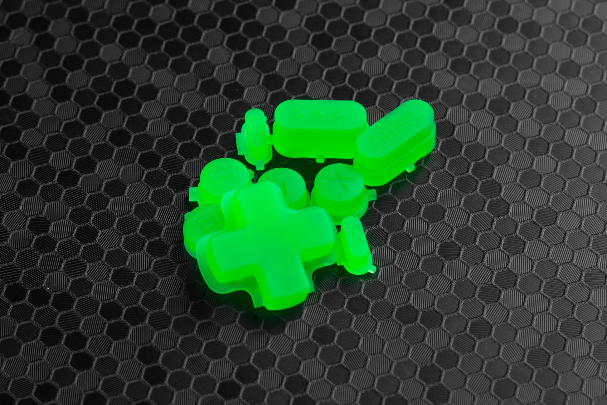 lime green steam deck buttons on a black honeycomb background