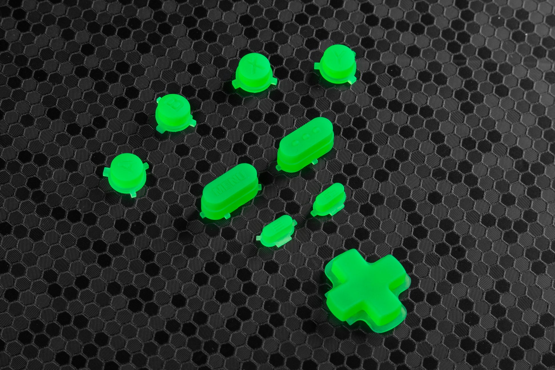 lime green steam deck buttons on a textured black surface