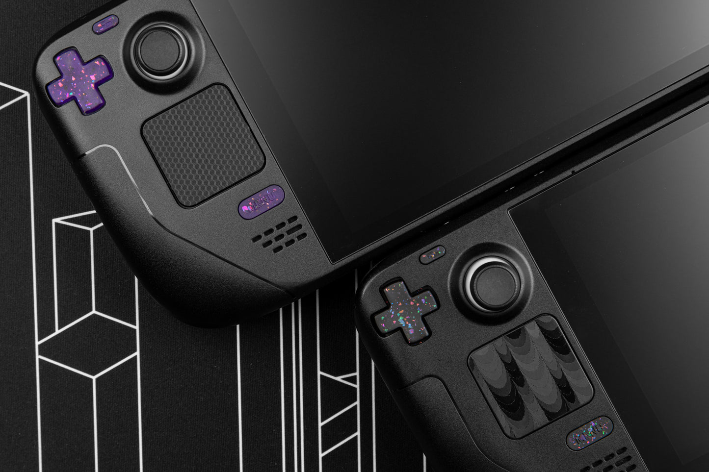 two steam decks with party black and party purple buttons installed. Steam decks at an angle showing the dpad side of the deck.