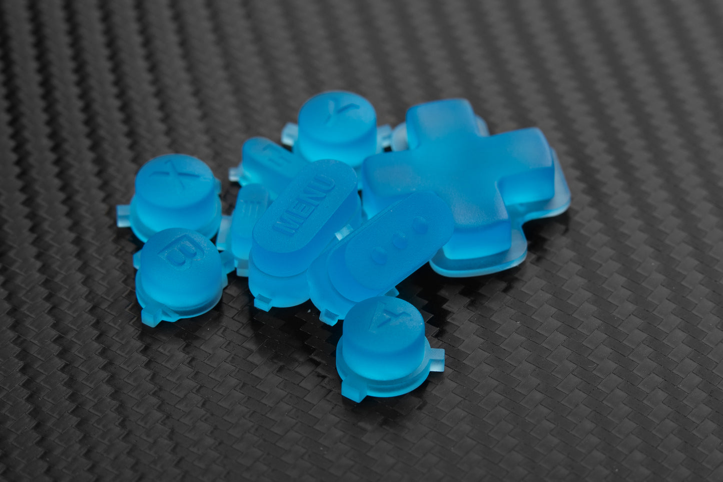 Steam deck buttons bright transparent Blue in a pile on carbon fiber background