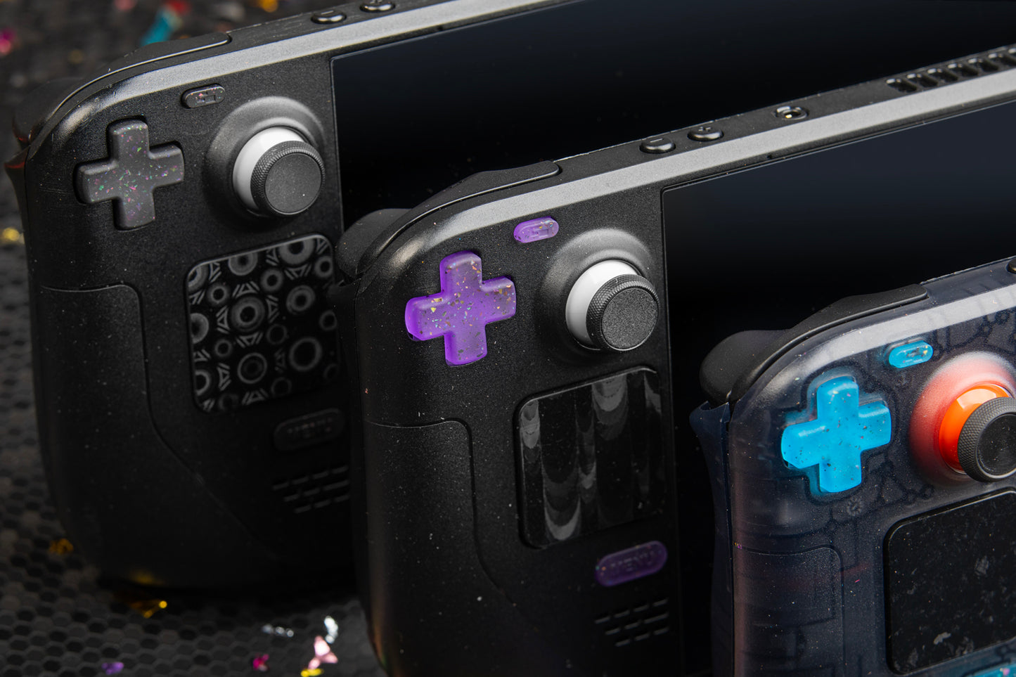 3 Steam decks in one shot. Showcasing dpads. Left: party black. Middle: party purple. Right: Party blue.
