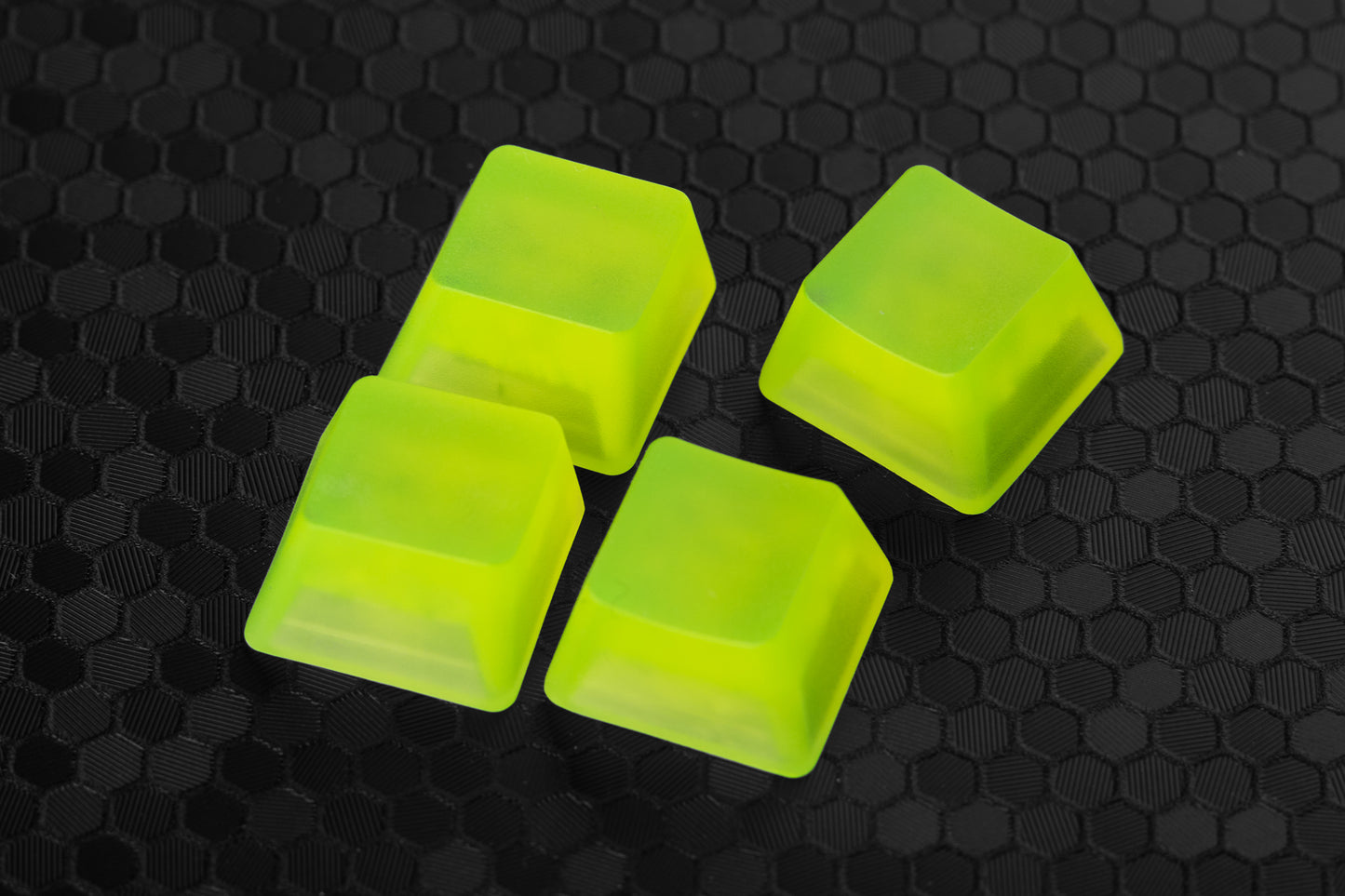 four transparent neon yellow artisan keycaps