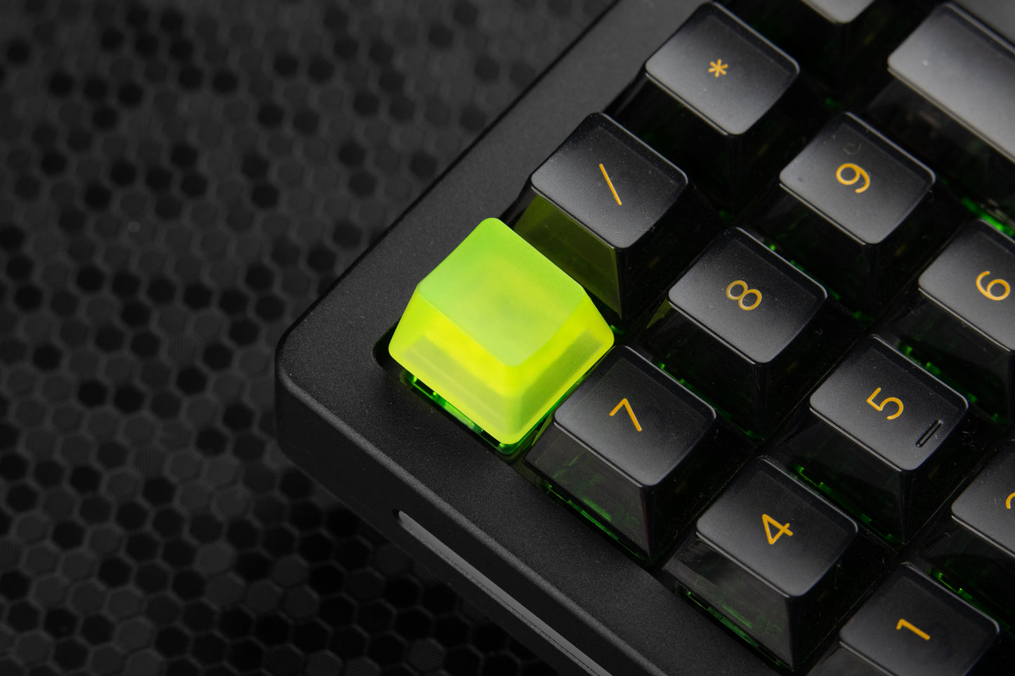 transparent neon yellow artisan keycap installed on a numpad