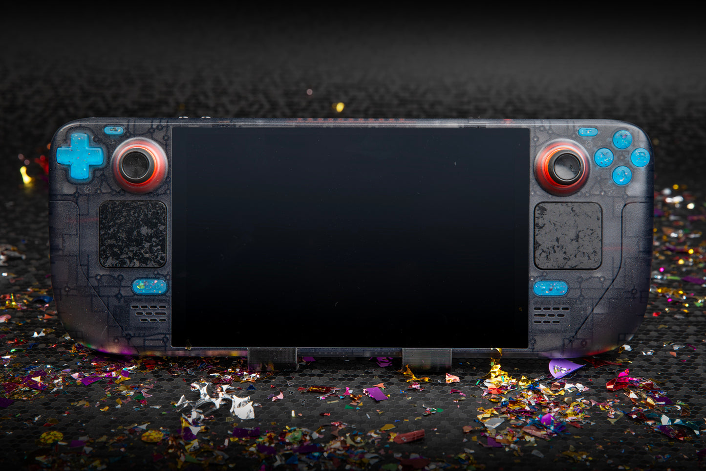 Wide shot of an LE steam deck surrounded by confetti. Party blue buttons installed.