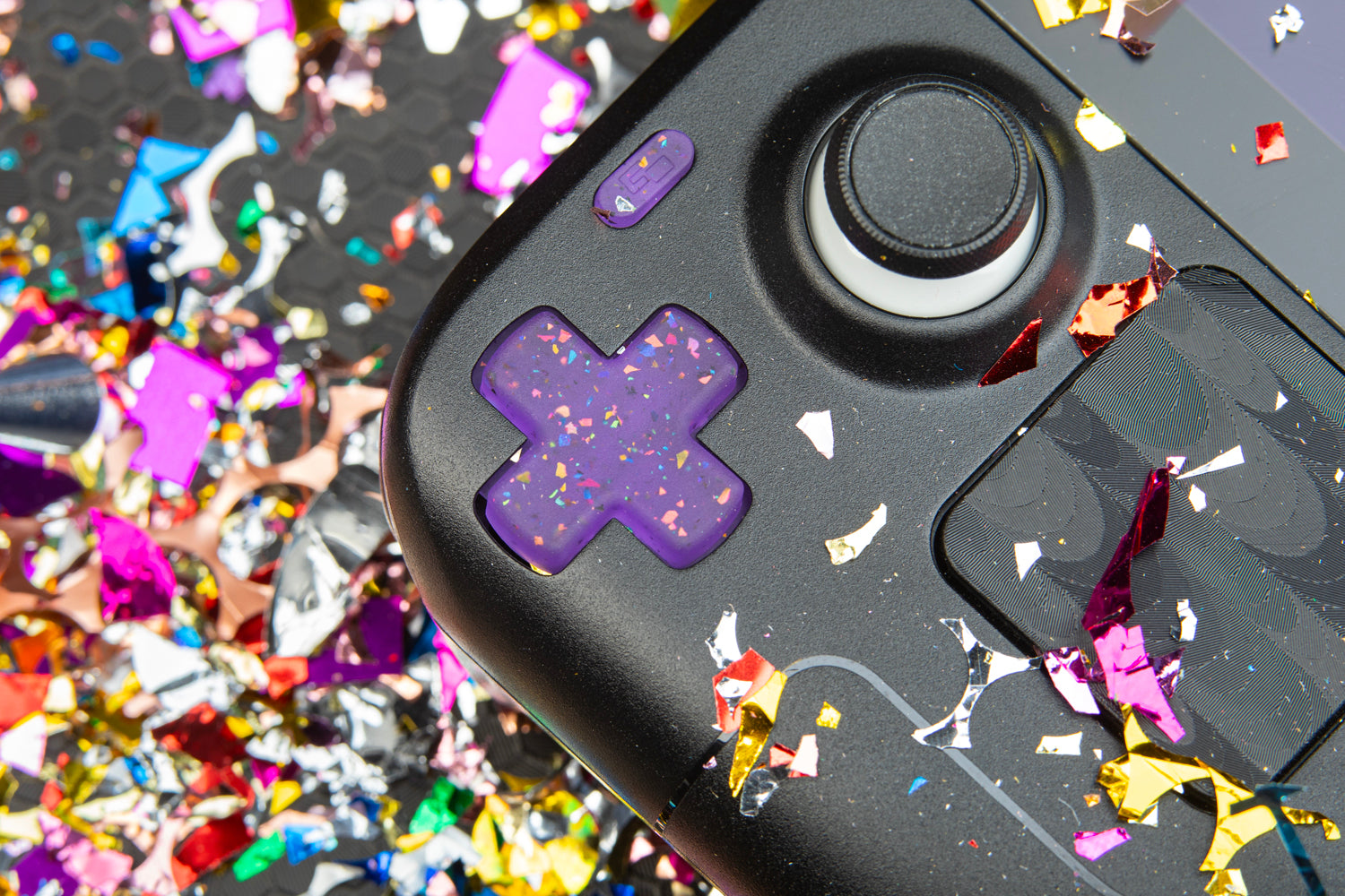 Steam deck with party purple dpad installed with confetti background