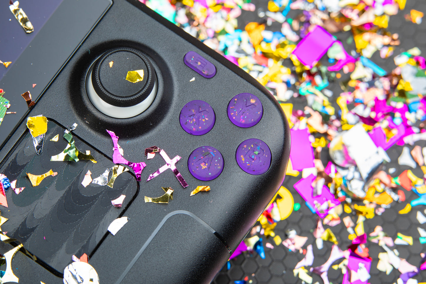 close up party purple abxy installed in steam deck with confetti background