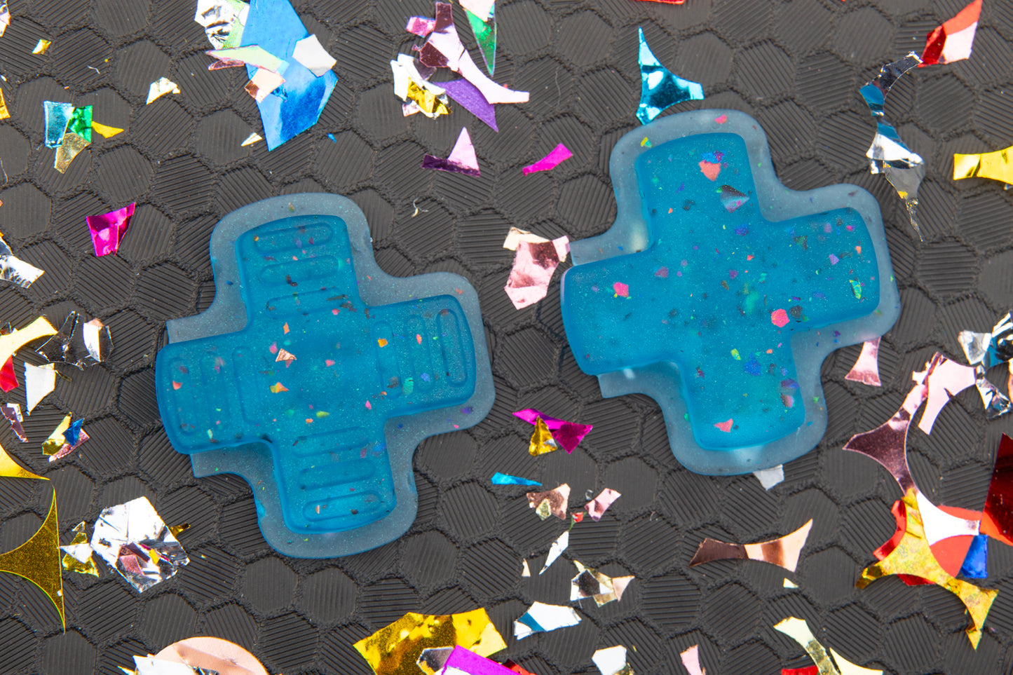 two party blue steam deck DPAD's on hex background with confetti. left is gameboy right is standard.
