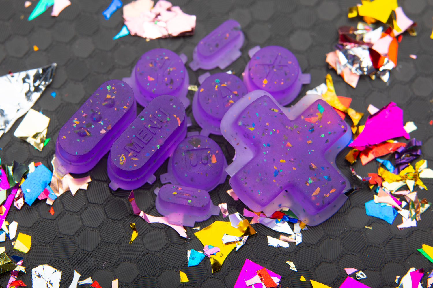 party purple steam deck button set in a pile on hex background with confetti