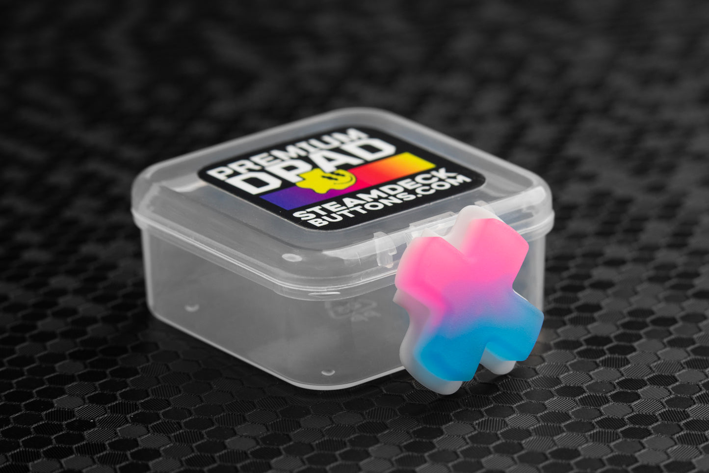 neon pink/blue gradient steam deck dpad resting against packaging