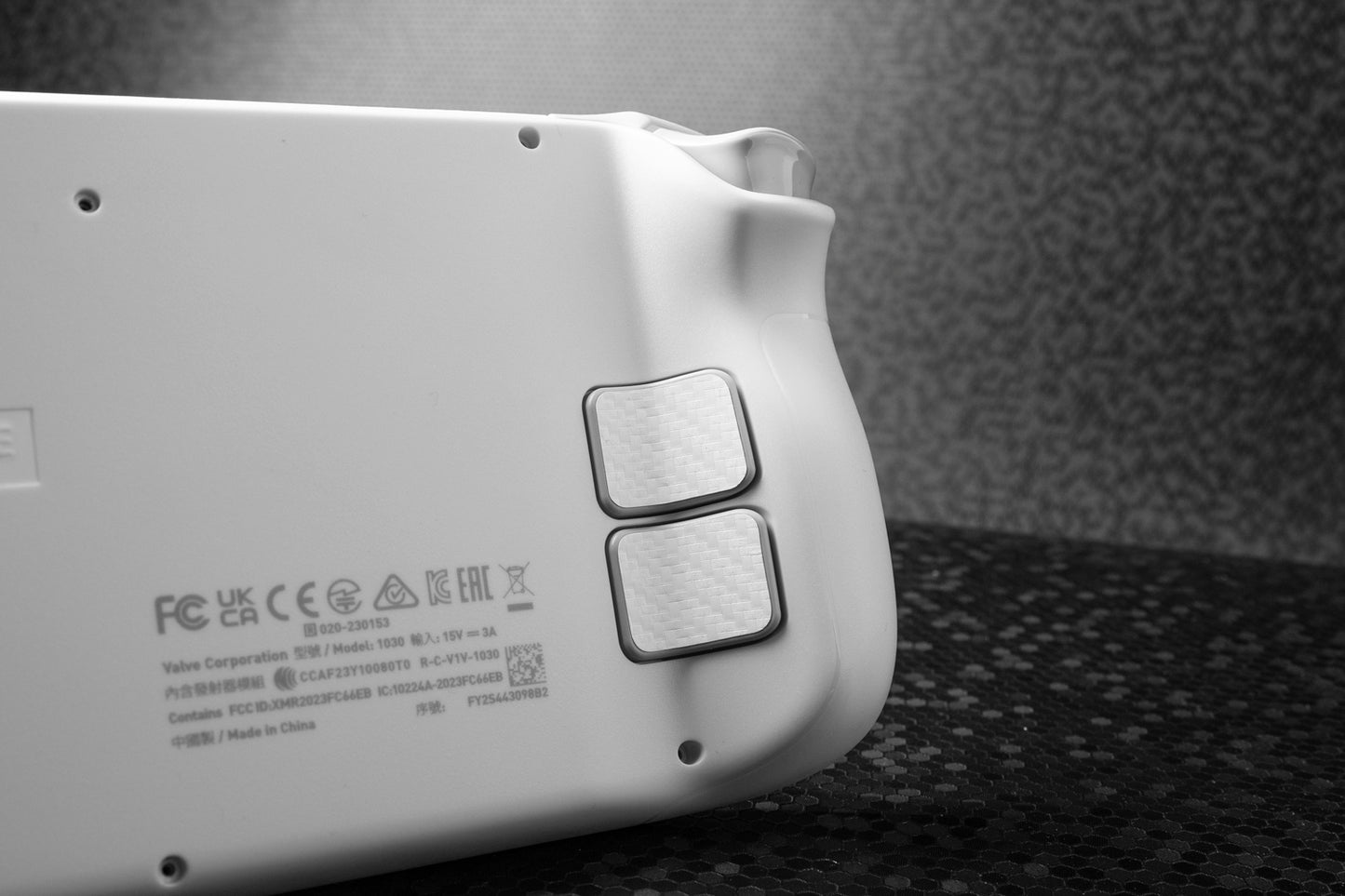 another angle of white carbon fiber touchrpotect gripbacks installed on a white limited edition steam deck
