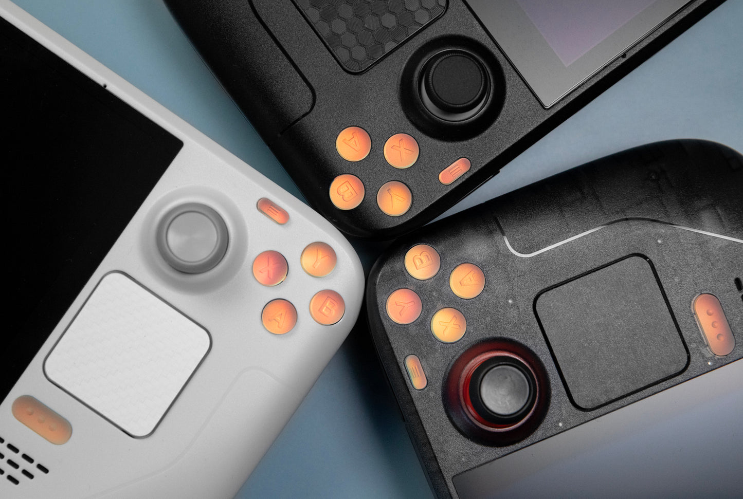 Three steam decks with holographic buttons installed. One standard two limited edition
