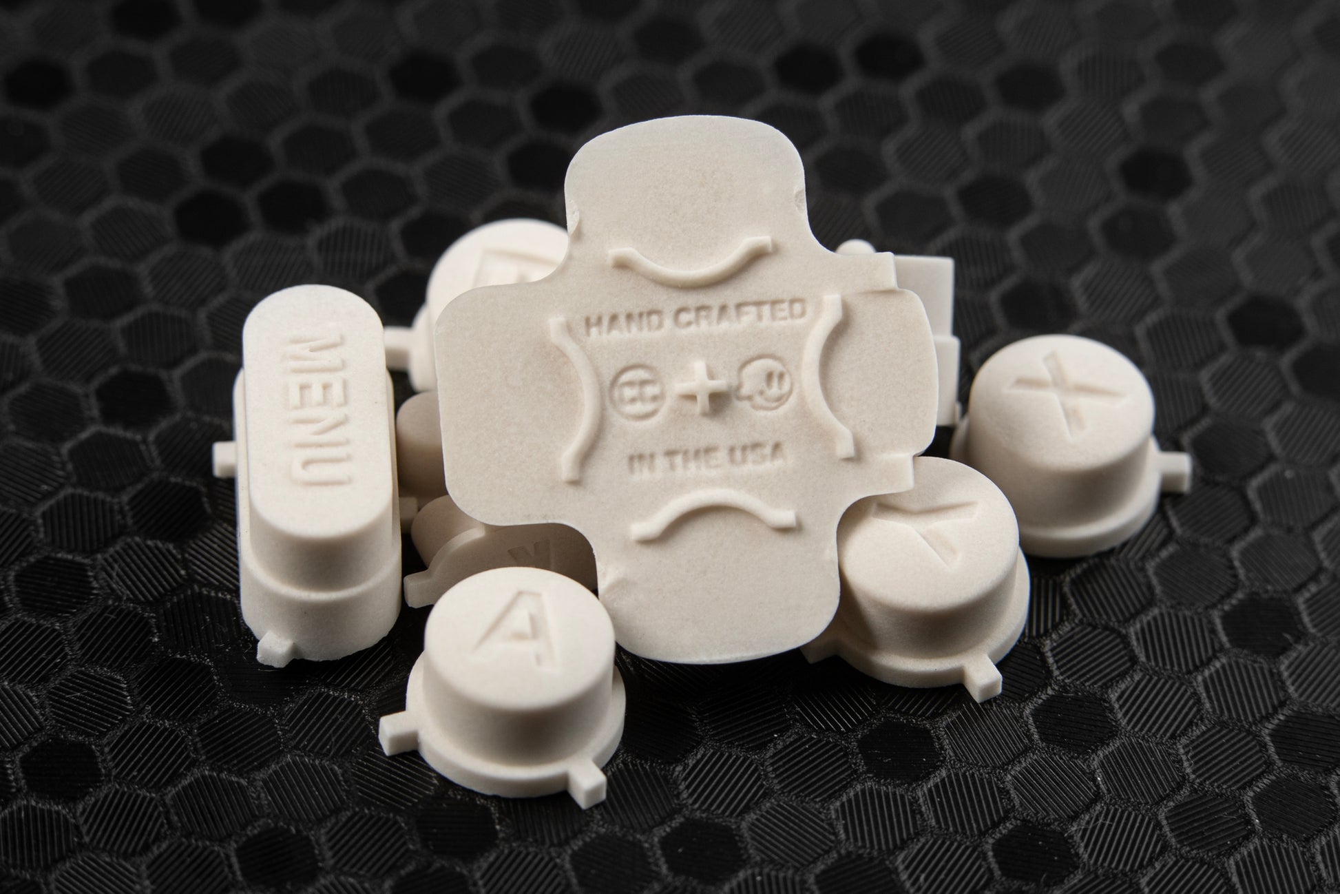 pile of steam deck buttons made of stone, back of dpad in center