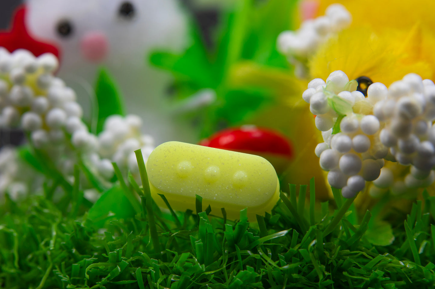 close up of quick access menu button sparkly yellow in fake grass scene