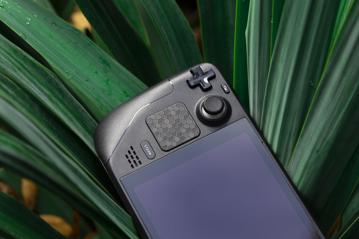 Steam deck in a plant with black hex touchprotect on trackpad