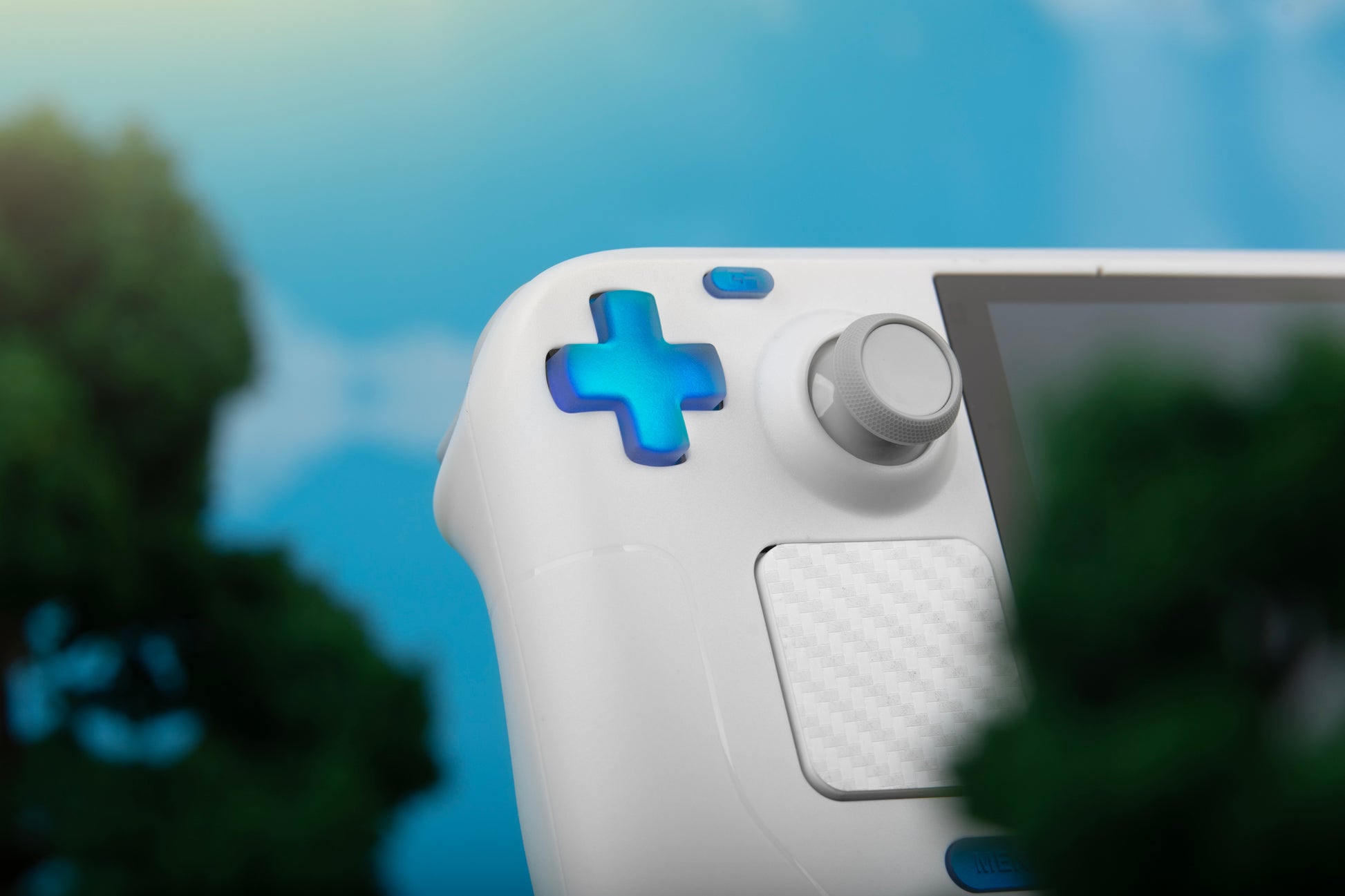 Close up of white steam deck with holographic blue dpad on a sunny day