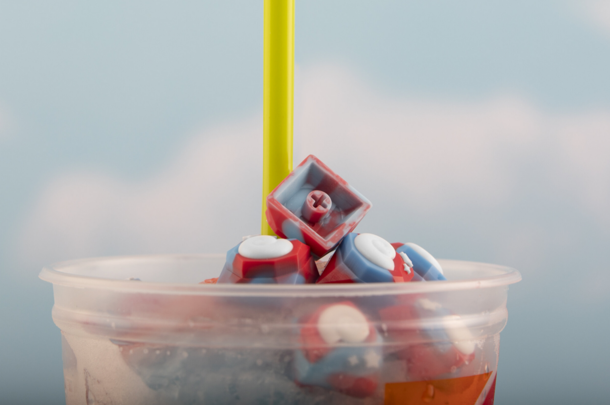 Animal crossing themed keyboard key inside a cup with straw sticking out