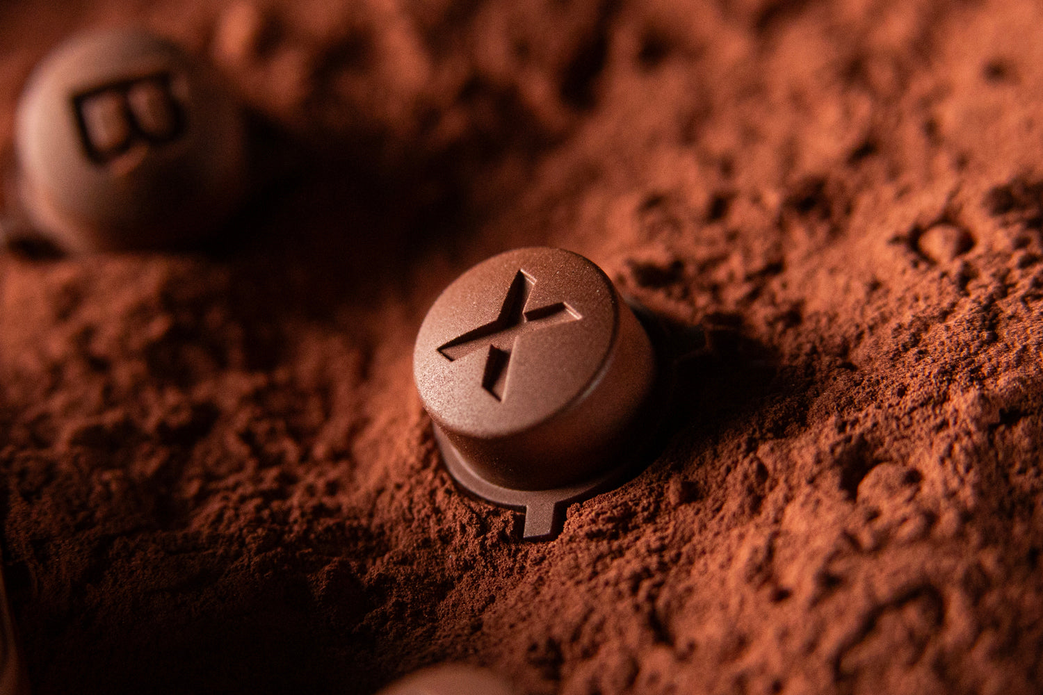 Copper Steam Deck Button - X sitting in raw copper powder