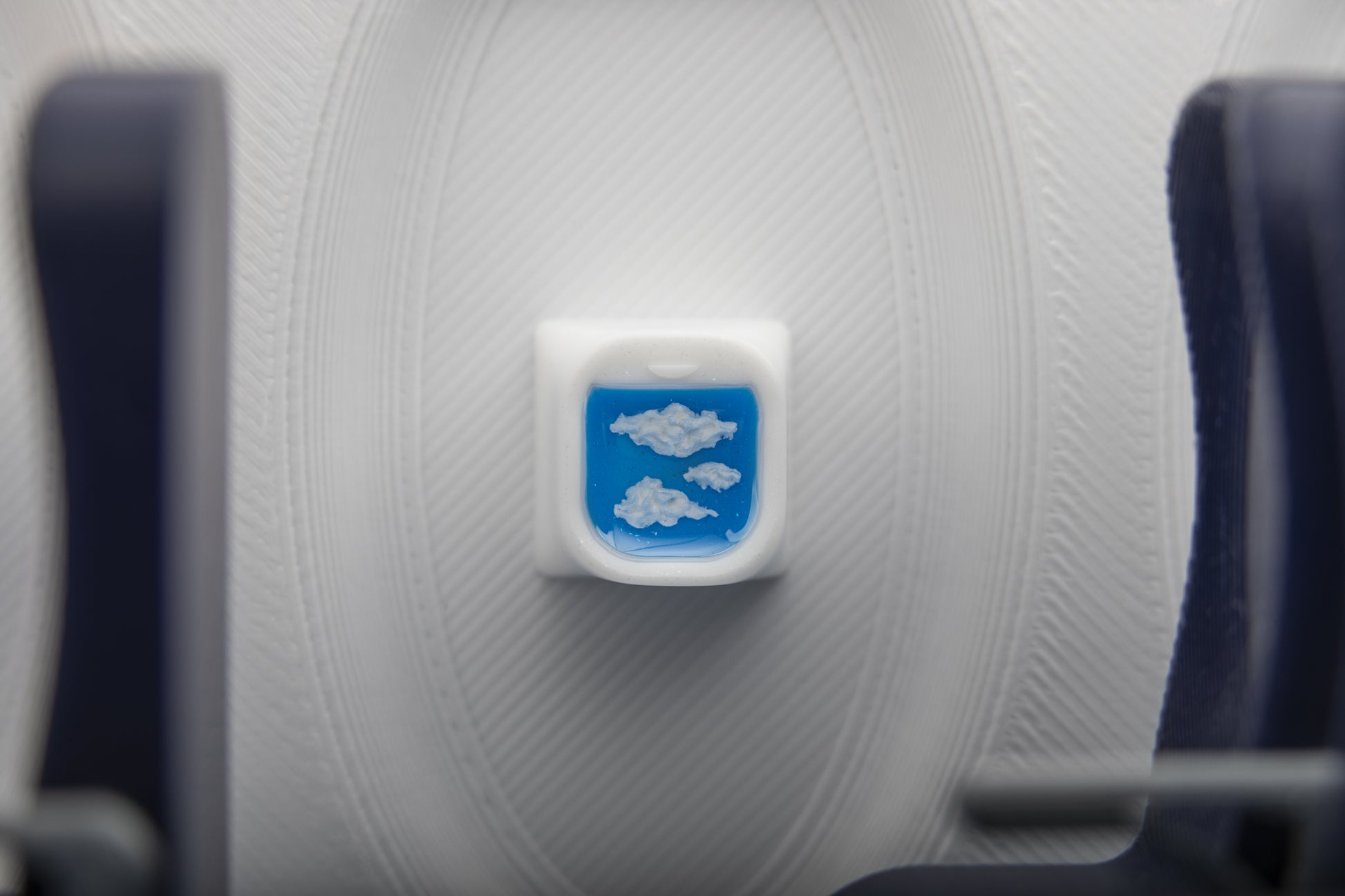 airplane window artisan keycap with clouds, view inside airplane