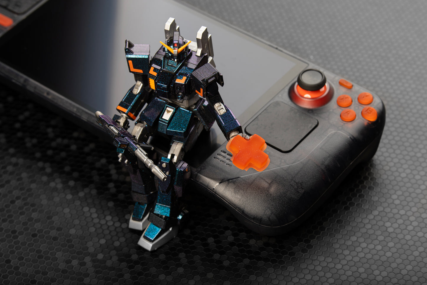 gundam sitting on a steam deck holding up a single dpad 