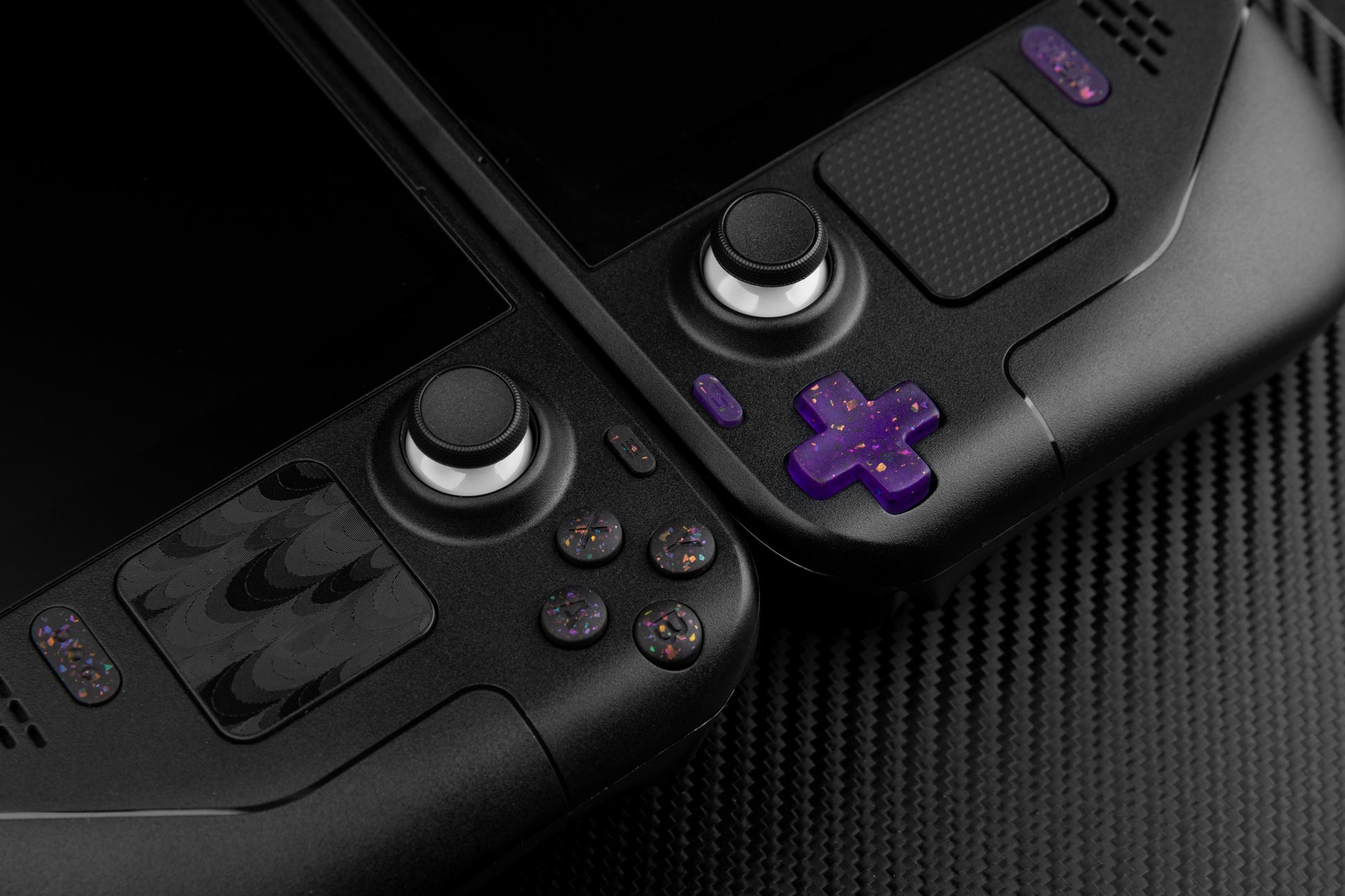 Two steam decks side to side with black and purple buttons installed