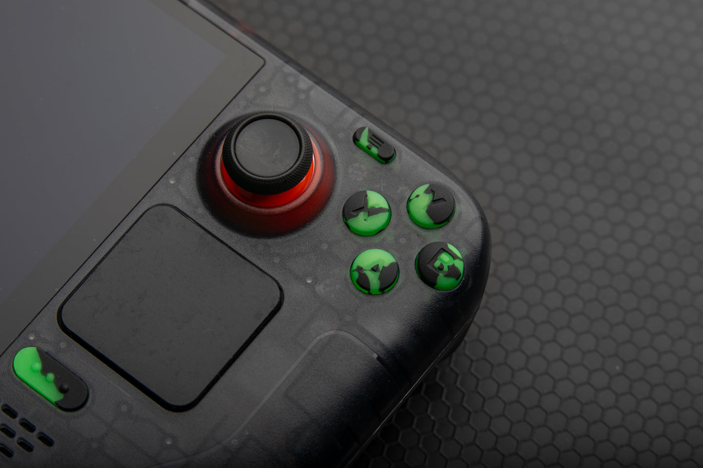 close up abxy steam deck buttons green and black splat. Honeycomb background
