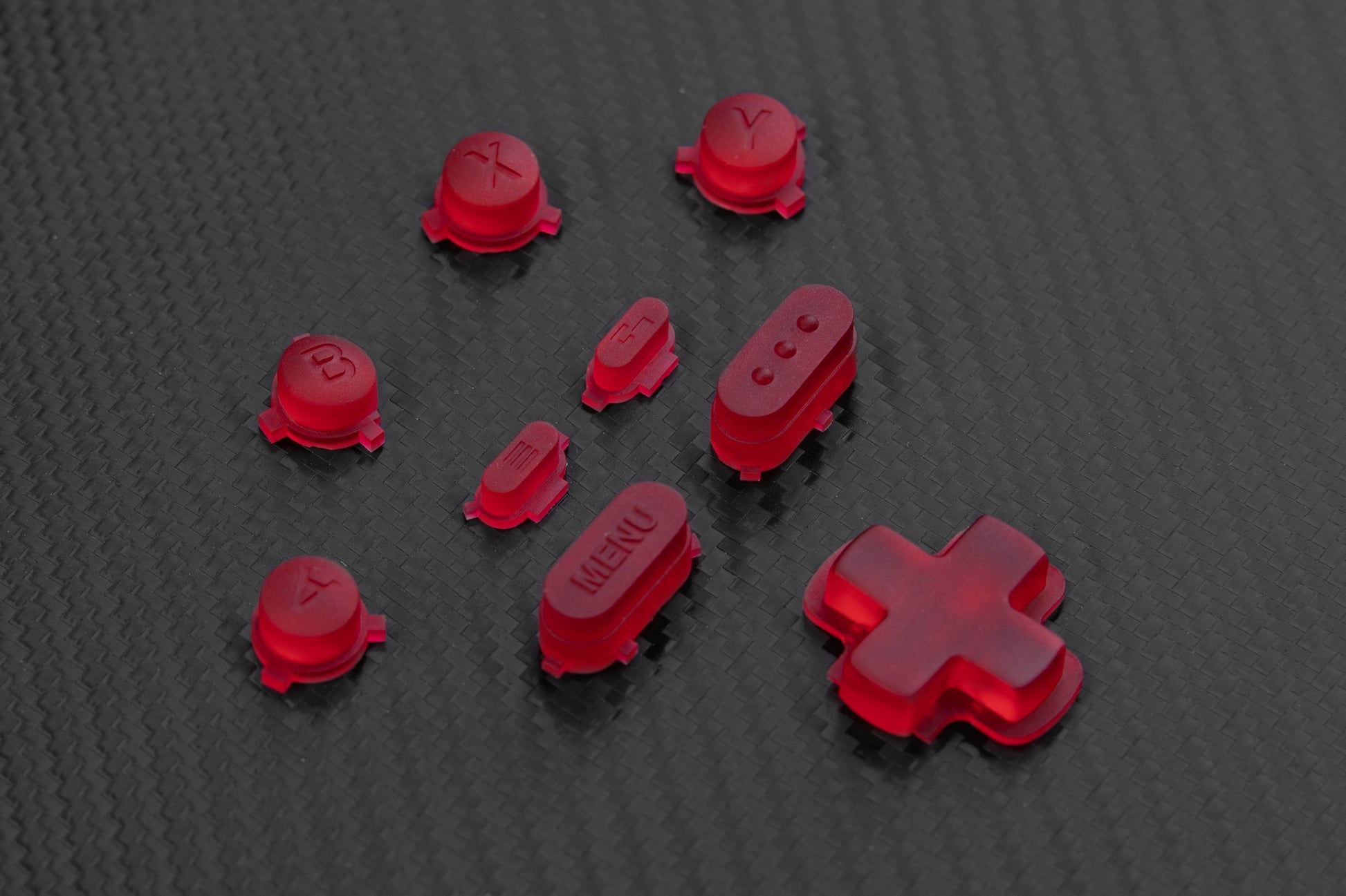 Crimson red steam deck buttons on a carbon fiber background