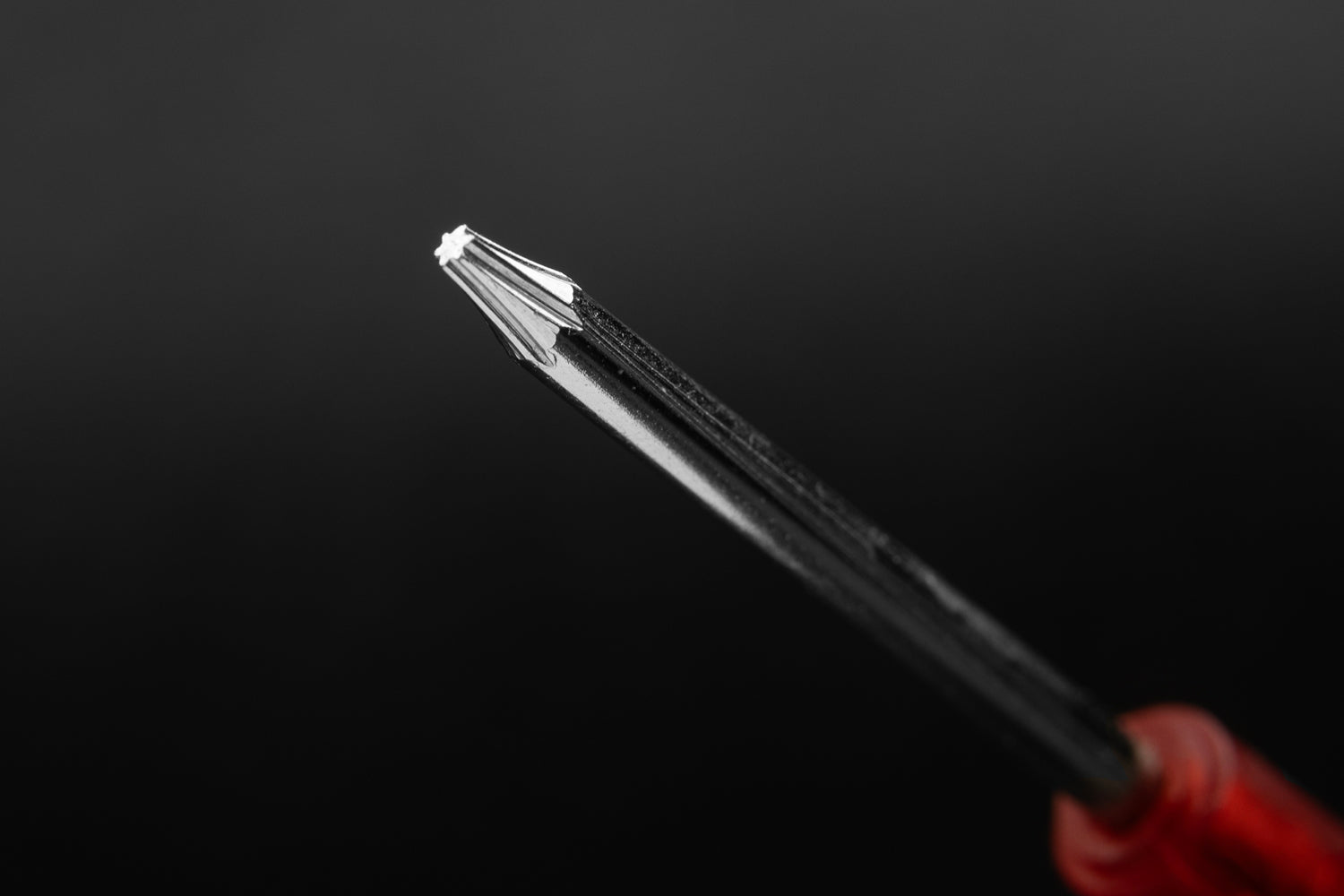 Close up of torx head on transparent head red screwdriver