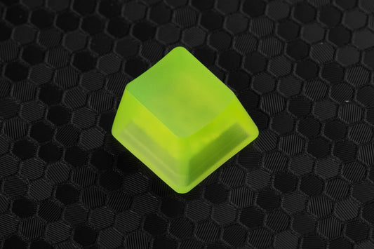 transparent neon yellow artisan keycap on a hex background 