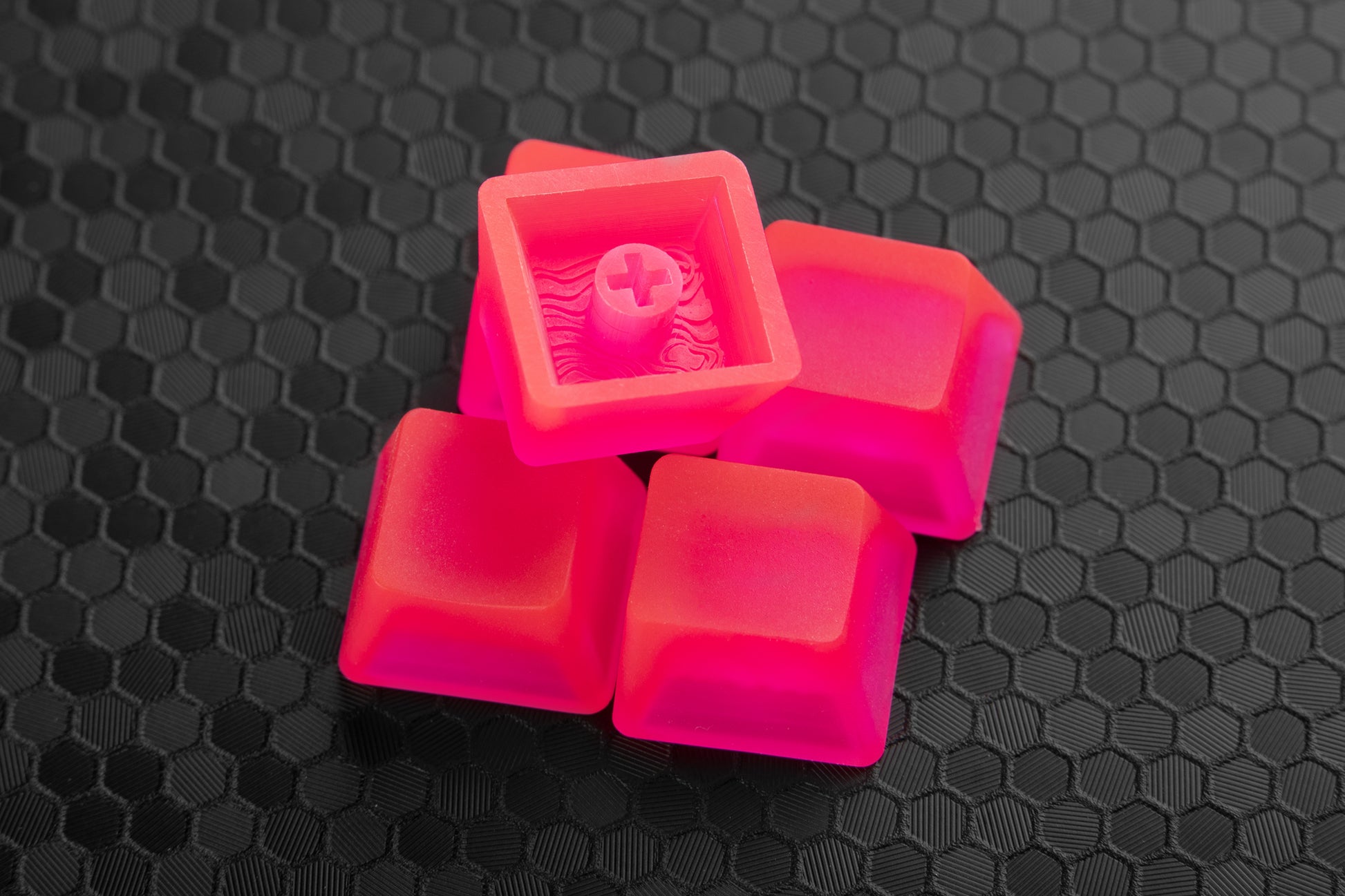Pile of transparent neon pink artisan keycaps