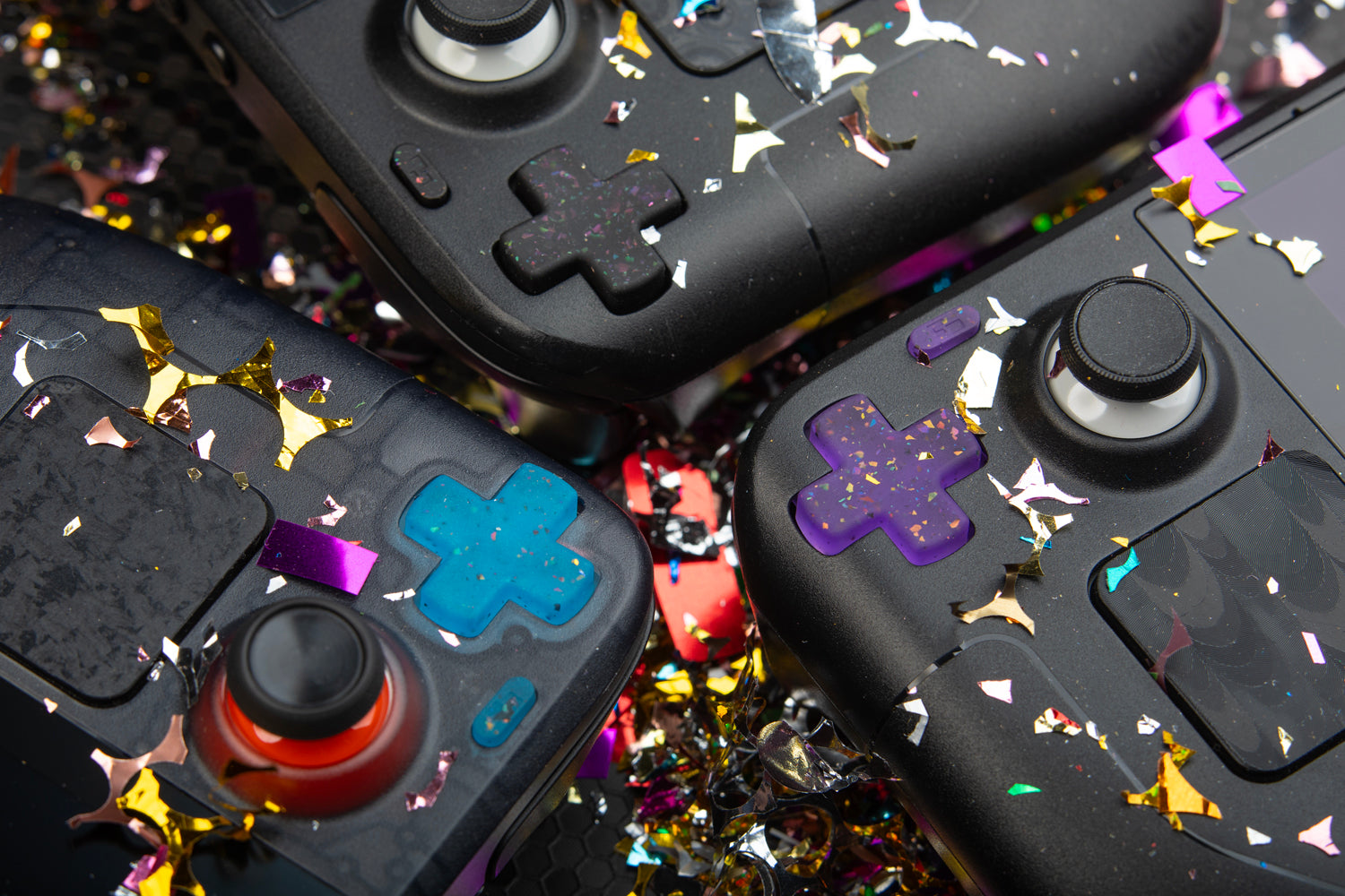 3 steam decks focused on dpads, confetti everywhere, party series installed blue purple black 