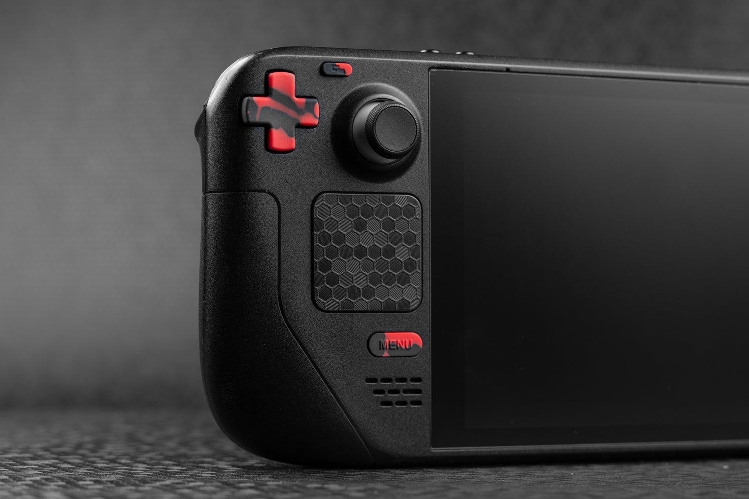 red blood splat on black steam deck button, dpad shown installed on a black steam deck