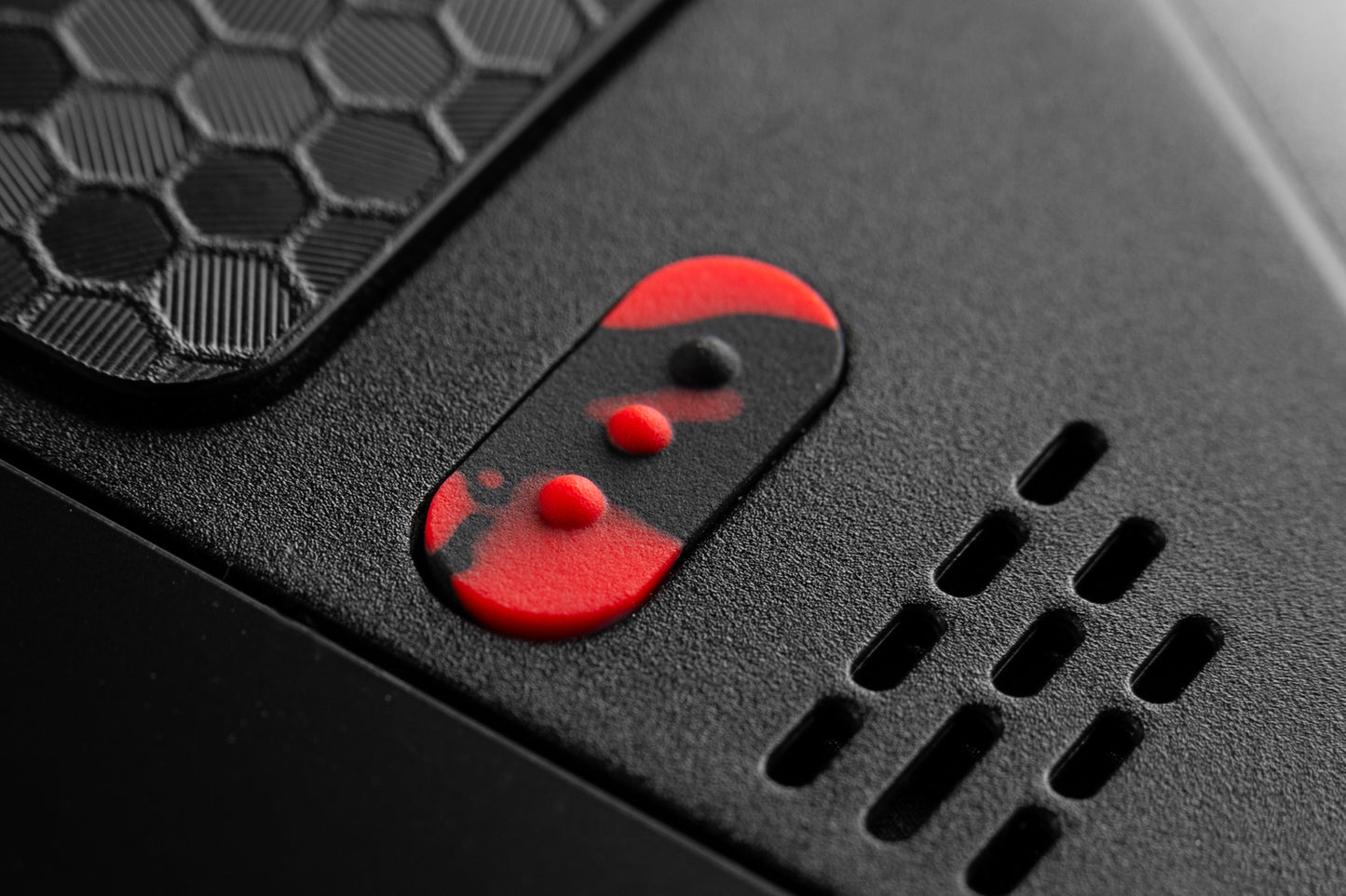 extreme close up of "3 dots" button installed. Black and red blood splat