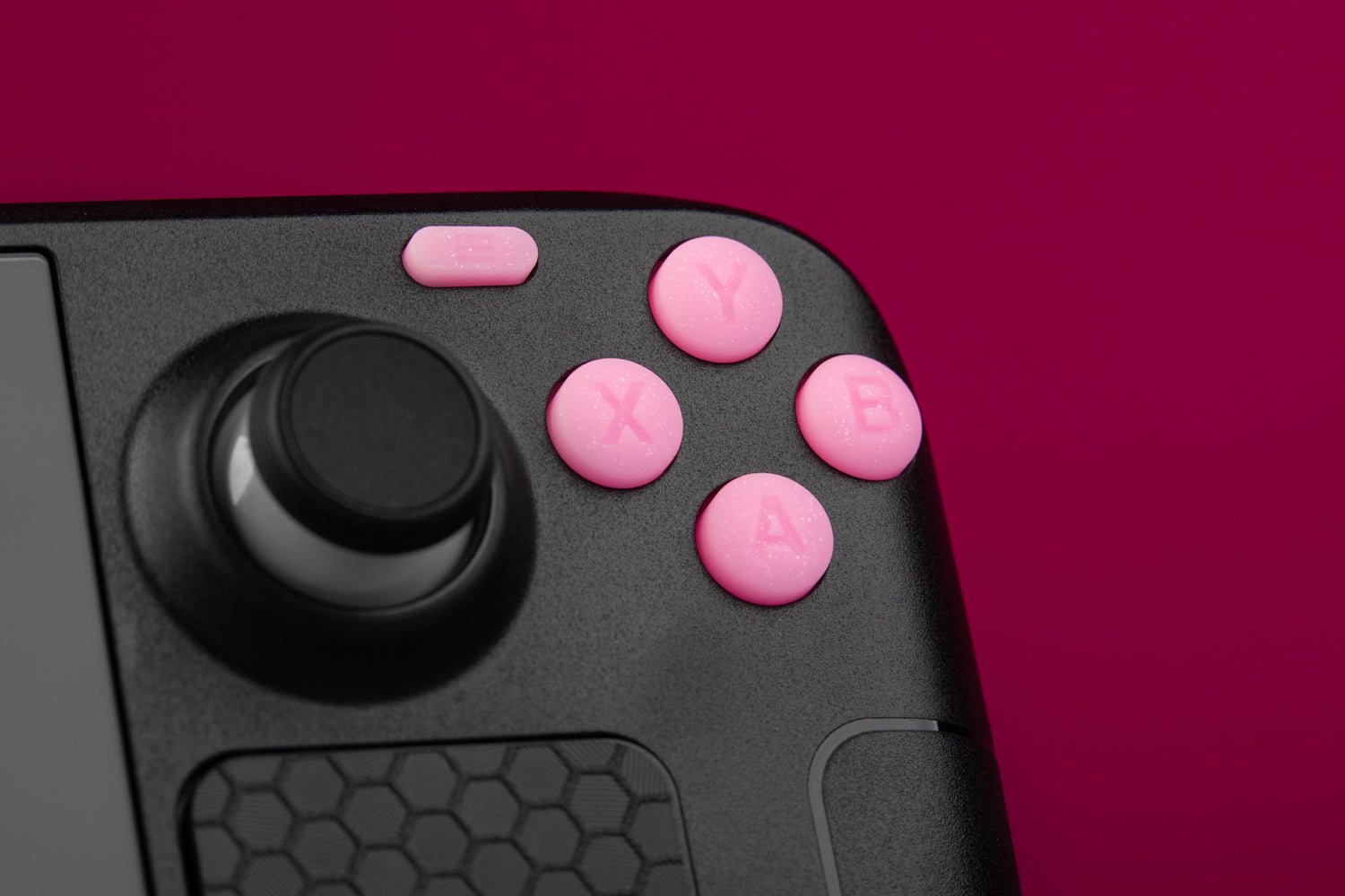 Close-up of ABXY buttons sparkly pink installed on a black steam deck