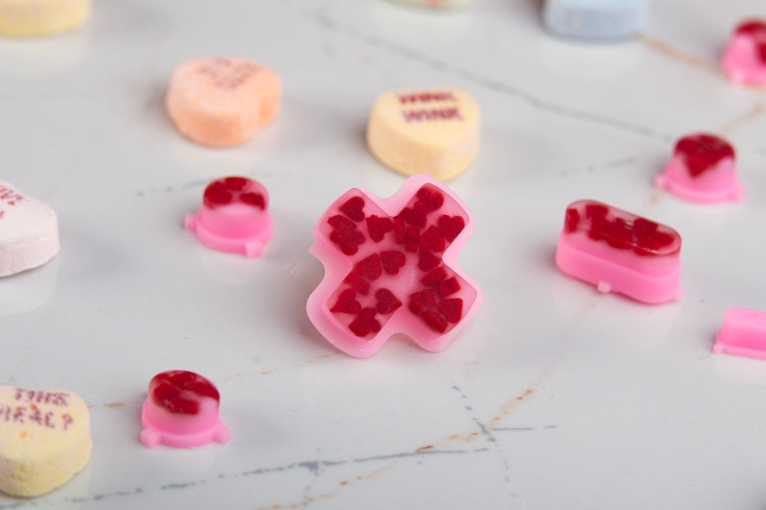 Close-up of a pink pad with red hearts encapsulated in it for the steam deck