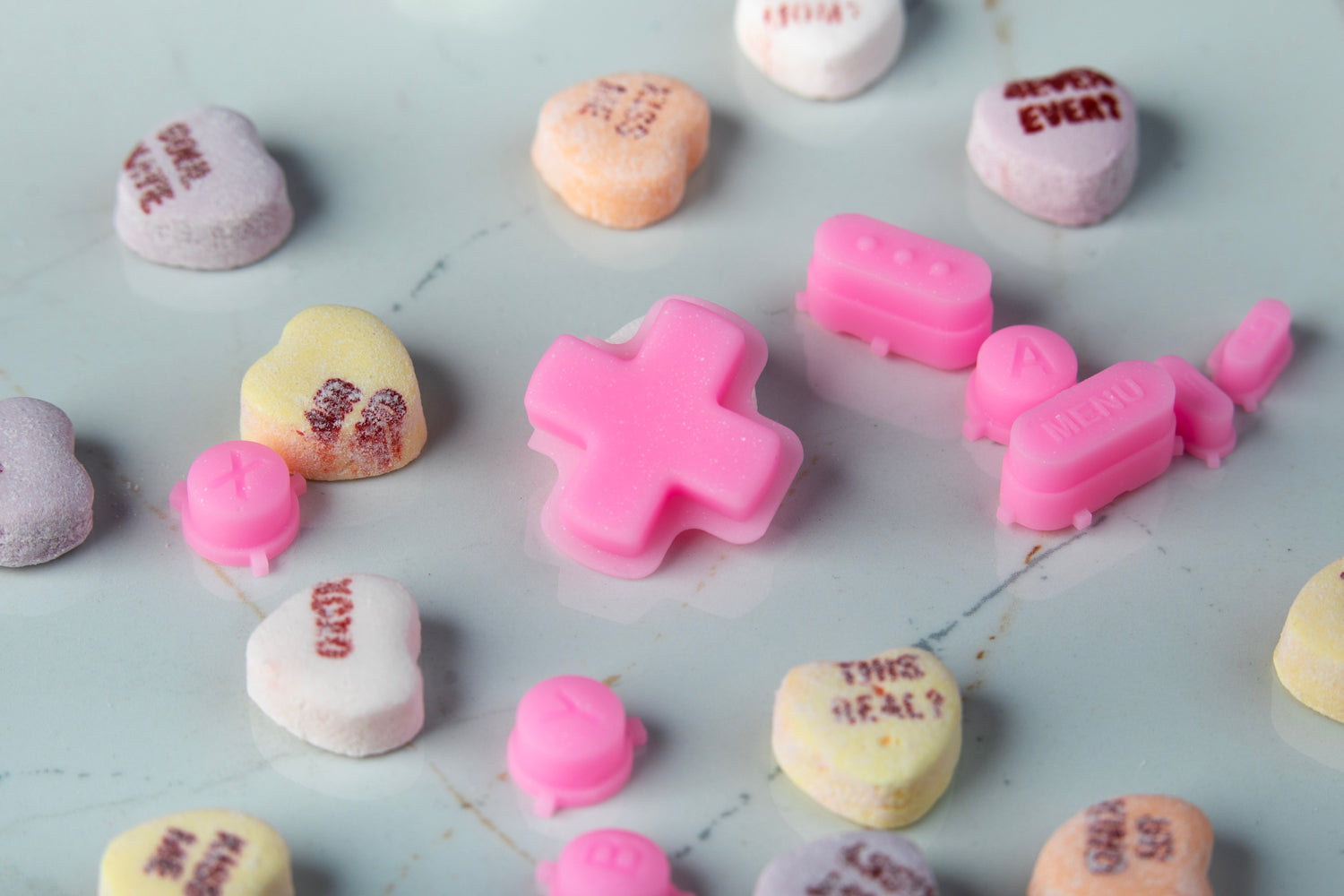 Sparkly pink Steam Deck buttons set surrounded by Valentine's hearts