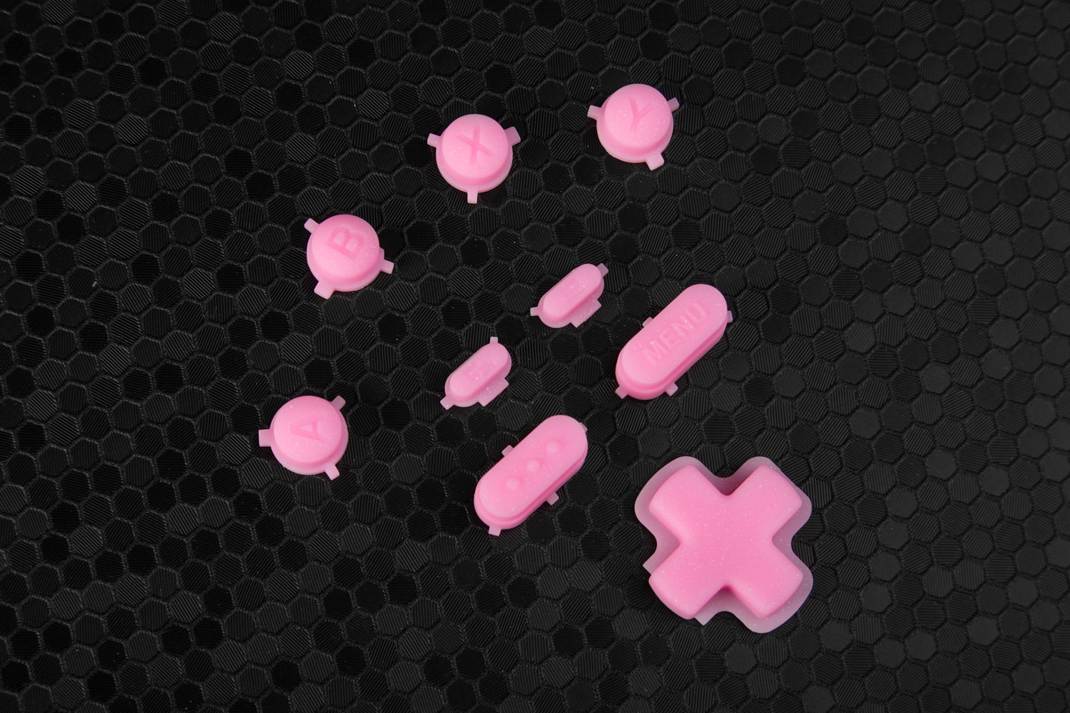 Sparkly pink Steam Deck buttons set on a hex background