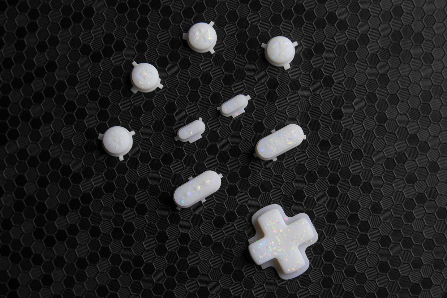 White steam deck buttons with holographic flake. Buttons spread out on hex pattern