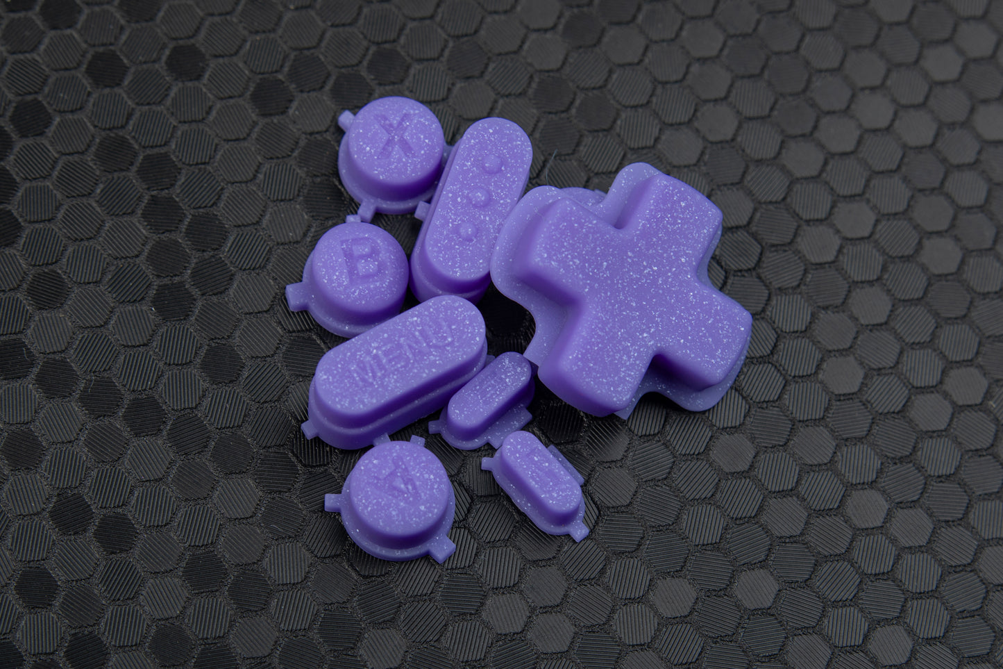 Purple sparkly steam deck buttons on a hex background