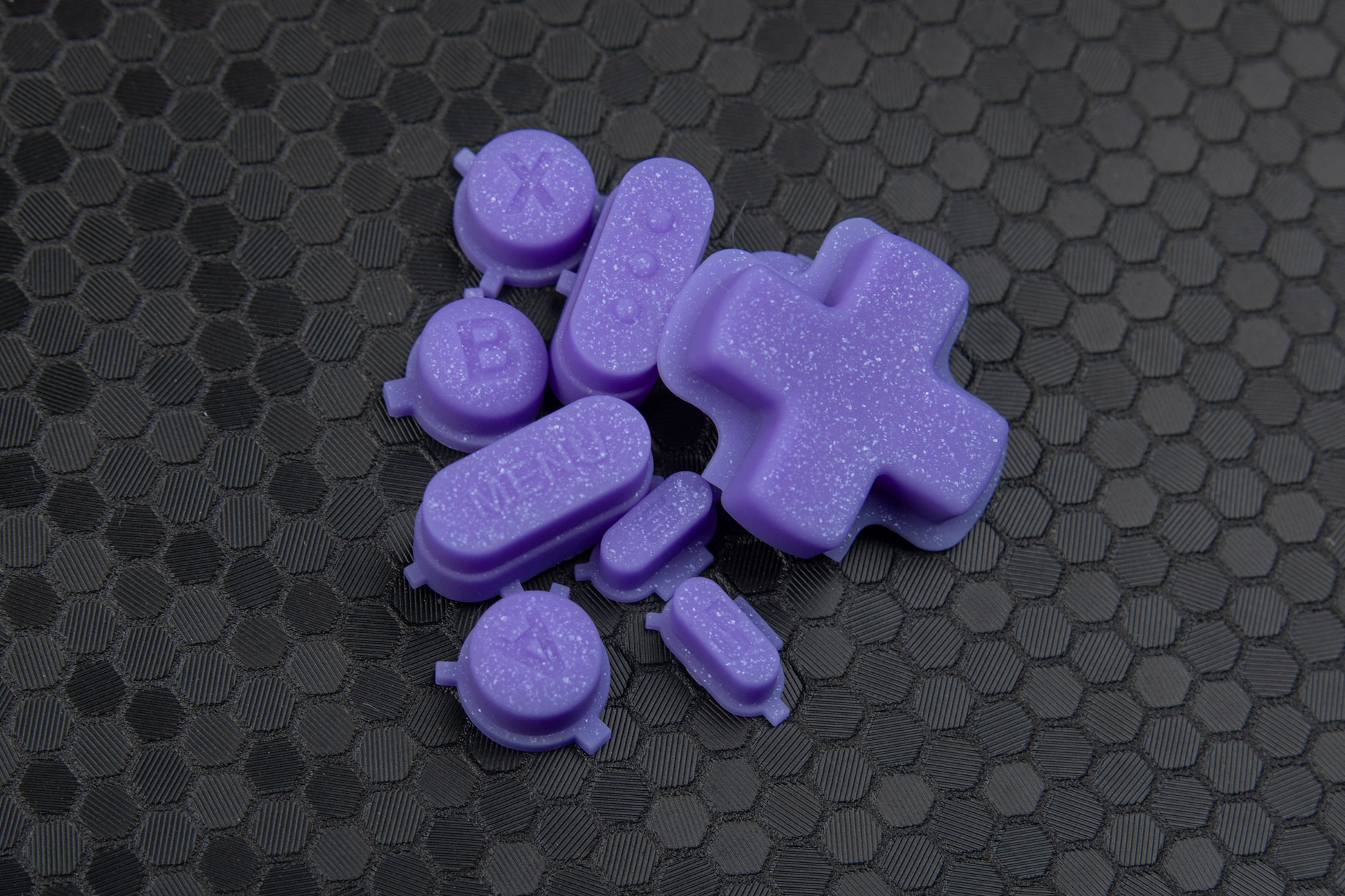 Purple sparkly steam deck buttons on a hex background