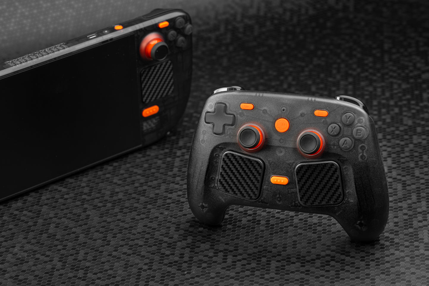Steam controller with matching steam deck next to it. Steam controller front of image. Smoked black color with orange accent buttons