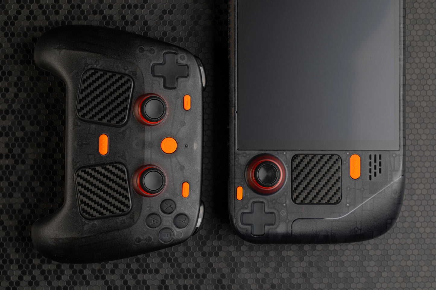 Steam controller with matching steam deck next to it. Smoked black color with orange accent buttons