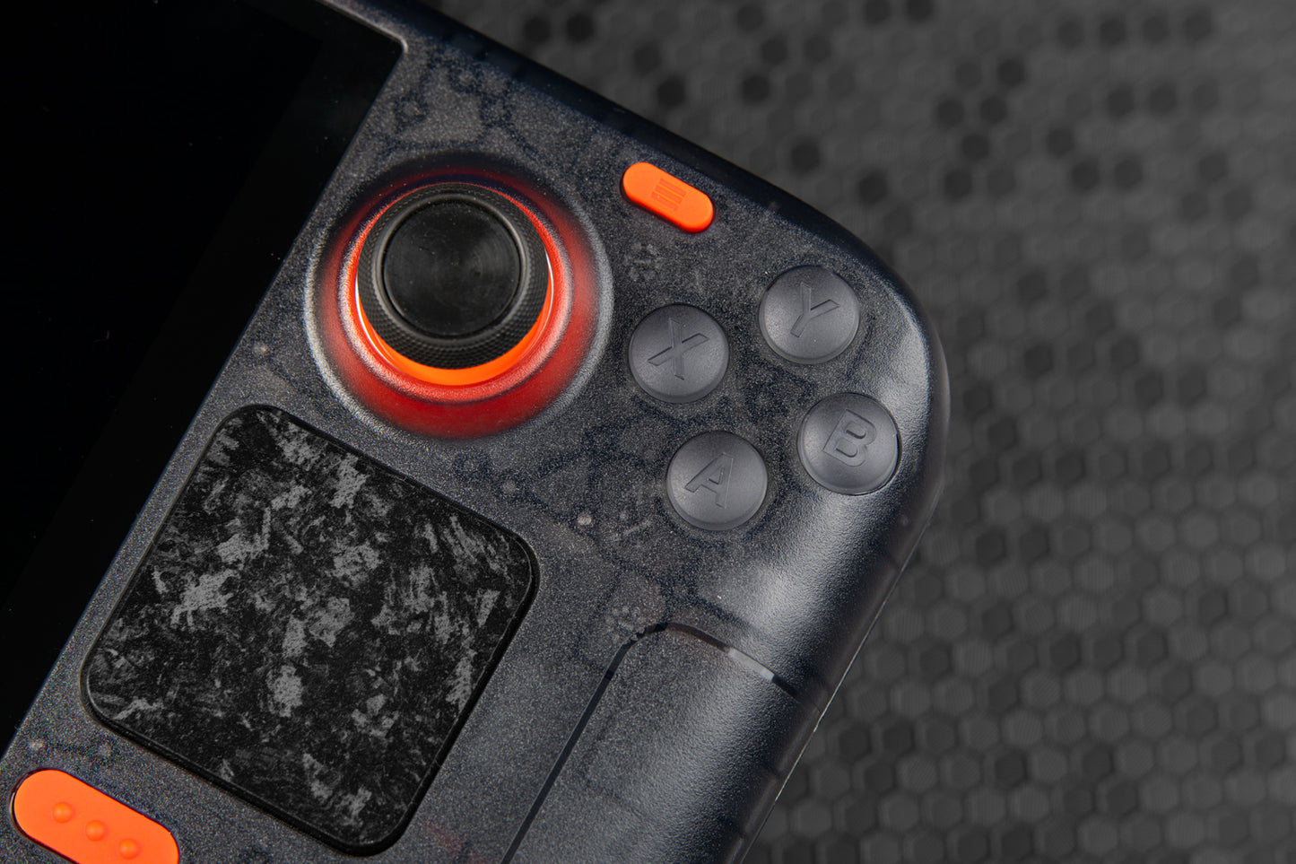 close up shot of right side of steam deck showing ABXY transparent grey buttons to match the LE steam deck, orange accented buttons as well