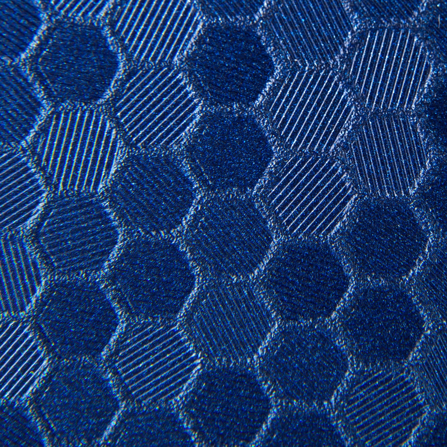 close up swatch of blue hex pattern. Hexagonal shapes with cross hatching in between 
